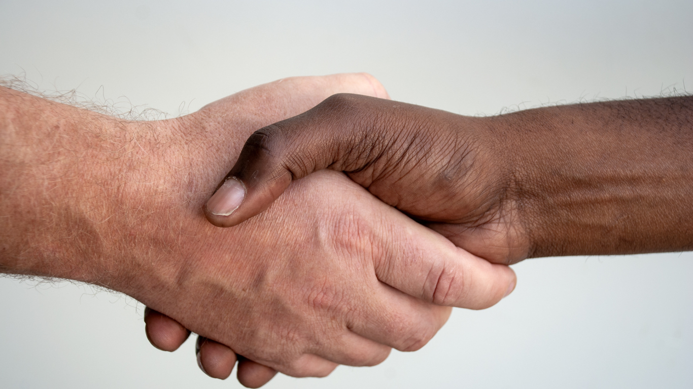 Two people shake their hands